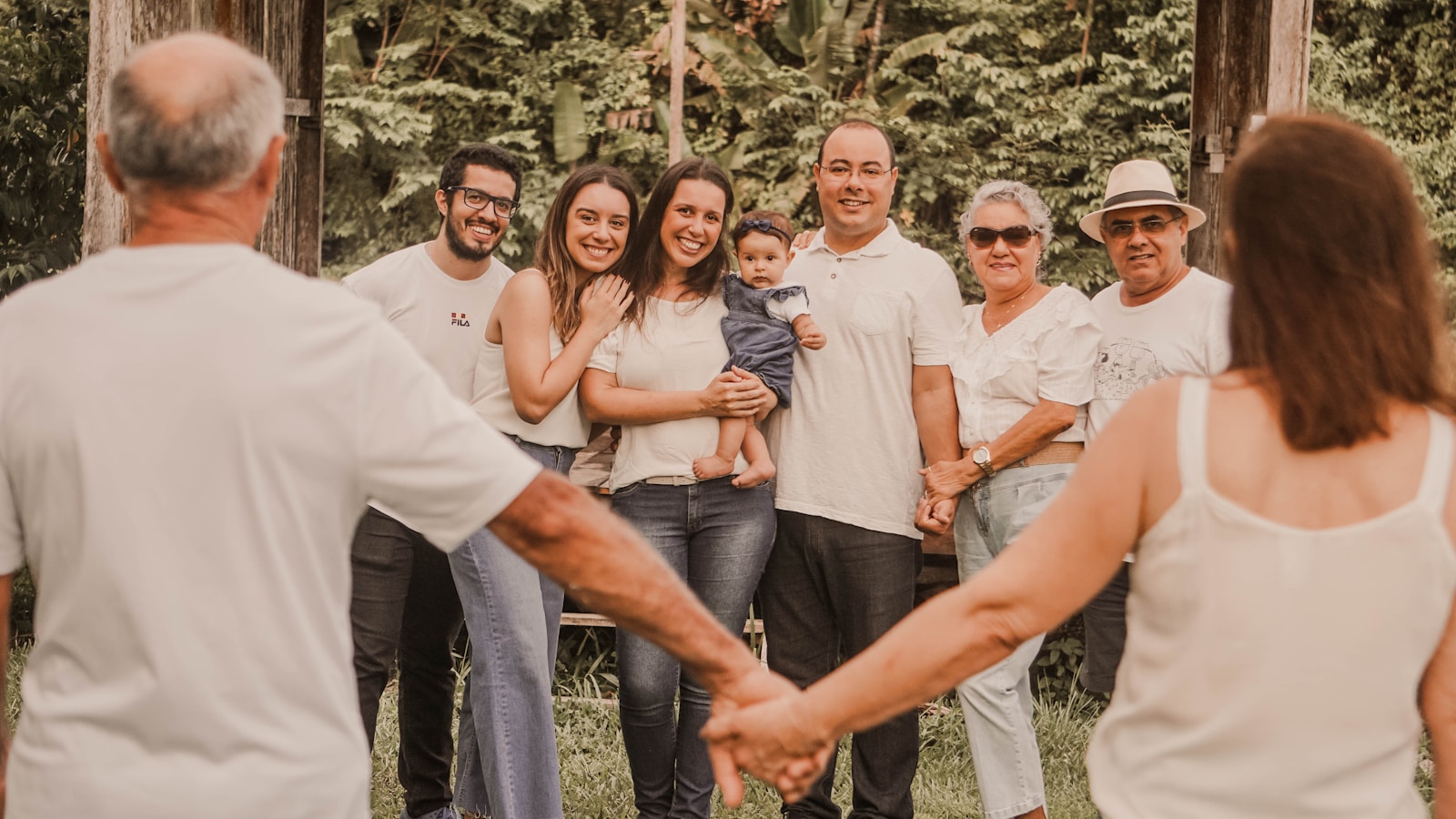 a group of people holding hands in front of trees, group medical